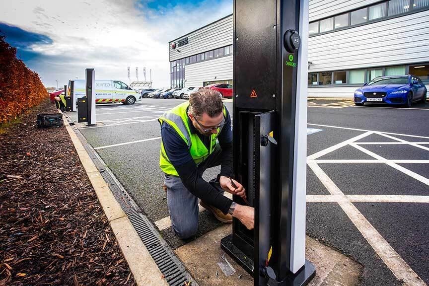 EV installer, servicing an EV charger